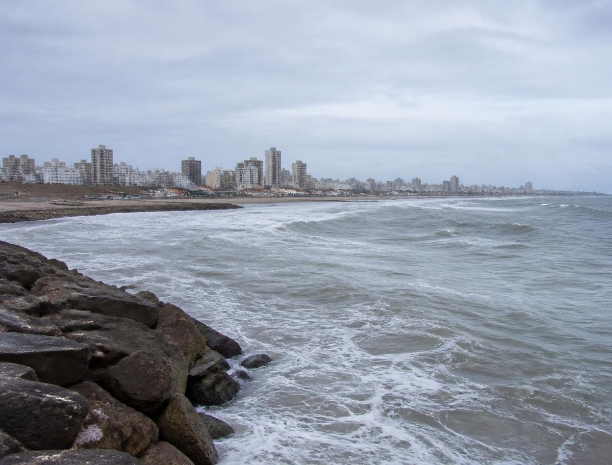 Wide sandy beach and breakwater rocks on the Atlantic coast at Mar del Plata